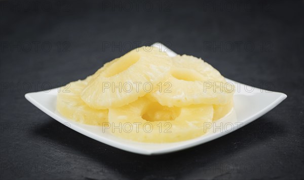Fresh made Preserved Pineapple Rings on a vintage background as detailed close-up shot