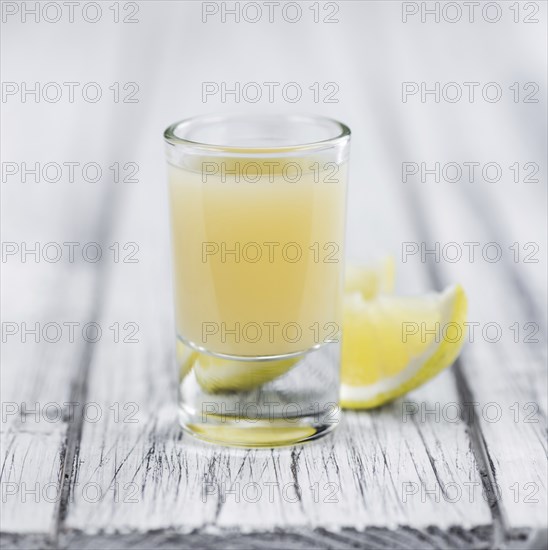 Fresh made Juice (lemon) on a vintage background (close-up shot)
