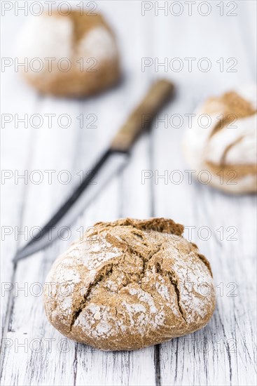 Fresh made Wholemeal Bun on a vintage background (close-up shot)