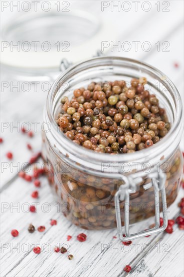 Portion of fresh preserved Pink Peppercorns close-up shot, selective focus