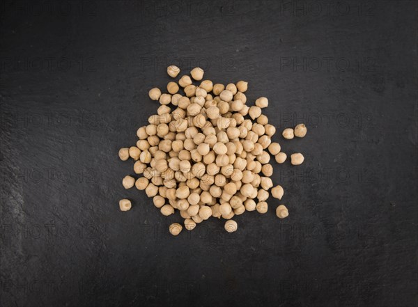 Chickpeas on a vintage background as detailed close-up shot, selective focus