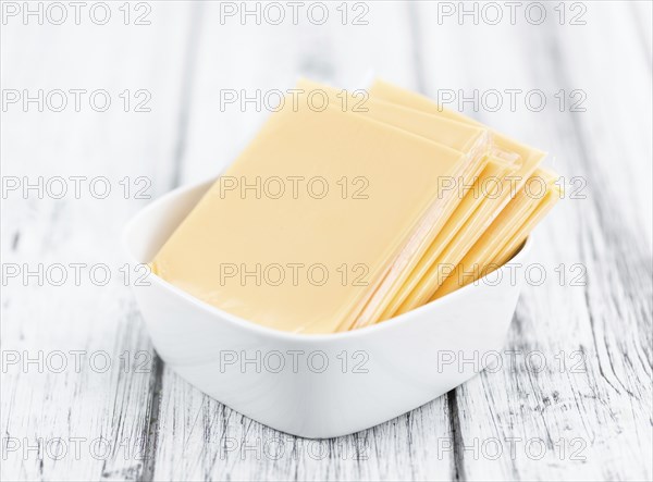 Portion of sliced Cheese (close-up shot, selective focus)