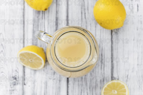 Lemon Juice on a vintage background as detailed close-up shot (selective focus)