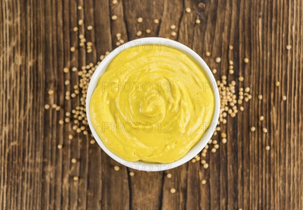 Mustard on a vintage background as detailed close-up shot (selective focus)