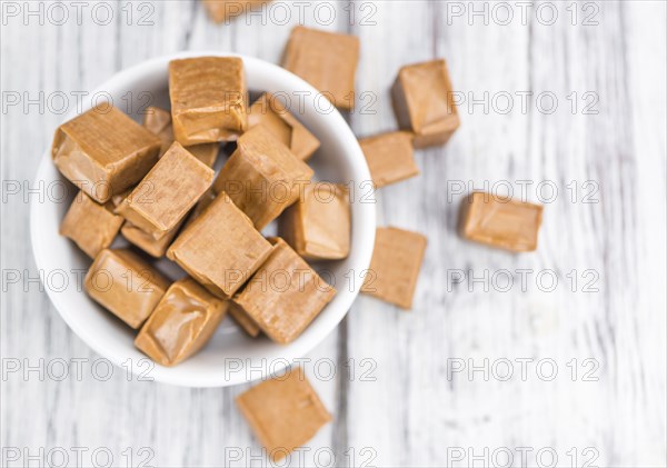 Caramel on a vintage background as detailed close-up shot (selective focus)