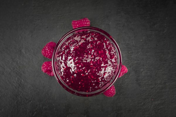 Fresh made Raspberry Jam on a vintage background as detailed close-up shot
