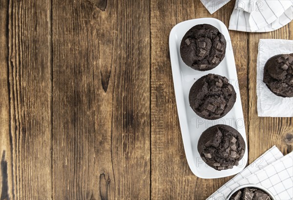 Some fresh Chocolate Muffins (selective focus, close-up shot)