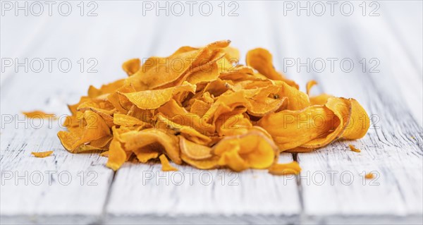 Homemade Sweet Potato Chips on vintage background selective focus, close-up shot