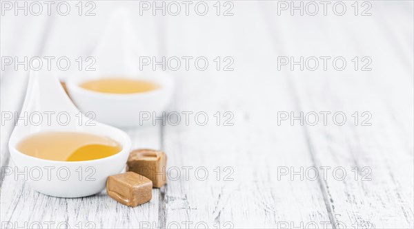 Caramel Sirup on a vintage background as detailed close-up shot (selective focus)