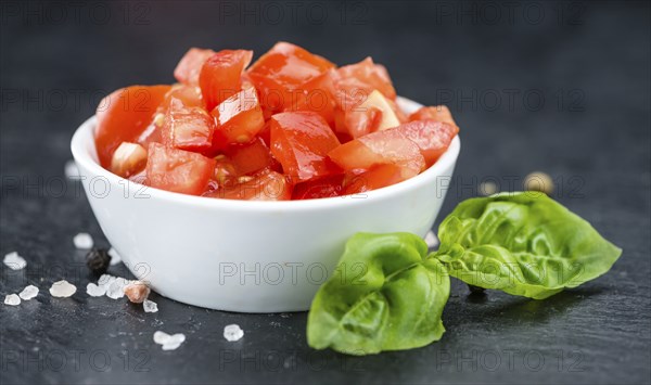 Homemade Cutted Tomatoes on vintage background (selective focus, close-up shot)