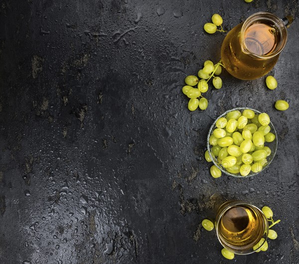 Some healthy Grape Juice on a vintage slate slab (selective focus)