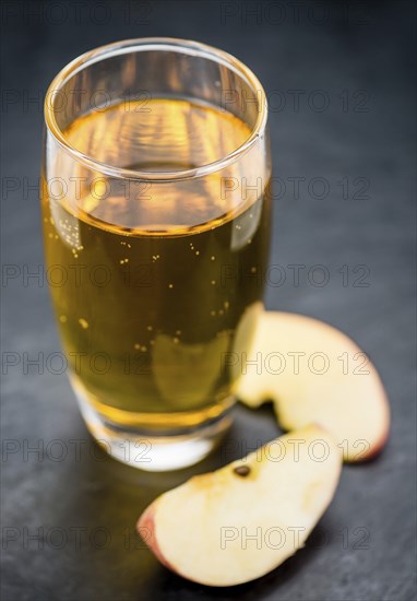 Fresh made Apple Cider on a vintage background (close-up shot)