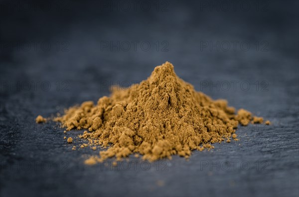 Fresh made Cinnamon Powder on a vintage background (close-up shot)