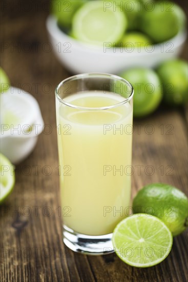 Lime Juice on a vintage background as detailed close-up shot (selective focus)