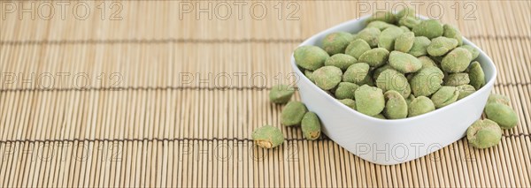 Wasabi Peanuts on a vintage background as detailed close-up shot (selective focus)