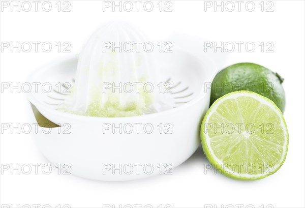 Portion of Lime Juice (as close-up shot) isolated on white background