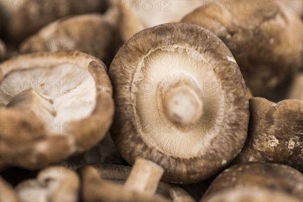 Shiitake mushrooms on a vintage background as detailed close-up shot, selective focus