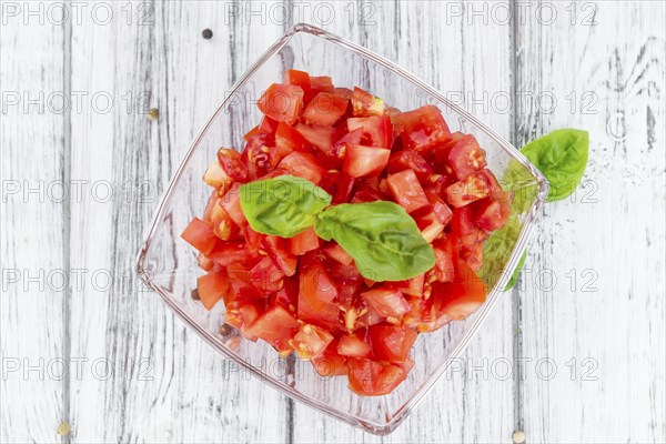Homemade Cutted Tomatoes on vintage background (selective focus, close-up shot)