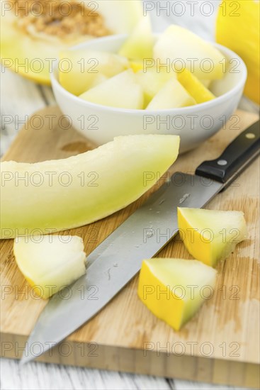 Fresh made Yellow Honeydew Melon on a vintage background (close-up shot)
