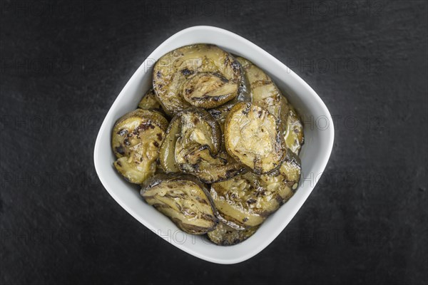 Homemade Antipasti (Grilled Zucchinis) on vintage background (selective focus, close-up shot)