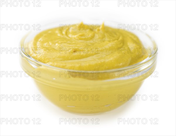 Portion of Mustard (as close-up shot) isolated on white background