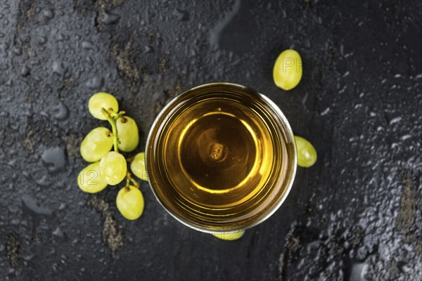 Portion of healthy Grape Juice on a slate slab (selective focus)