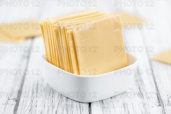 Portion of sliced Cheese (close-up shot, selective focus)