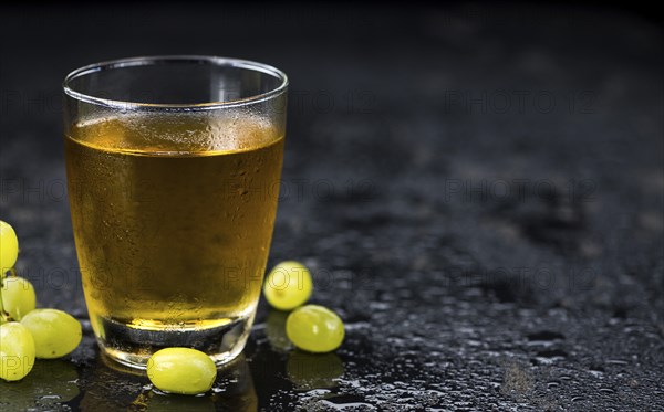 Some healthy Grape Juice on a vintage slate slab (selective focus)