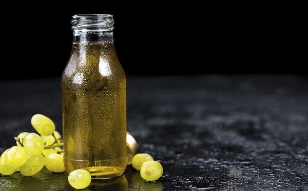 Some healthy Grape Juice on a vintage slate slab (selective focus)