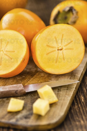 Kaki fruits on a vintage background as detailed close-up shot (selective focus)