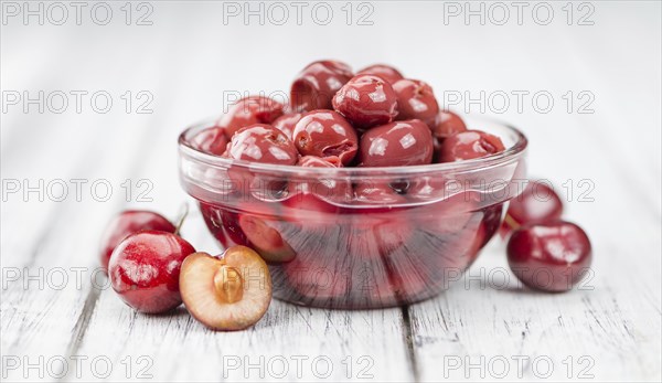 Preserved Cherries on a vintage background as detailed close-up shot, selective focus