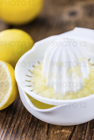 Lemon Juice on a vintage background as detailed close-up shot (selective focus)
