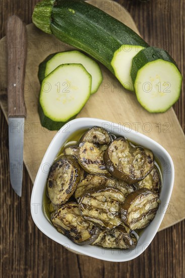 Fresh made Zucchinis (grilled) on an old and rustic wooden table (selective focus, close-up shot)