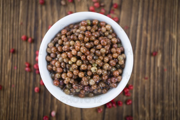 Portion of fresh preserved Pink Peppercorns close-up shot, selective focus
