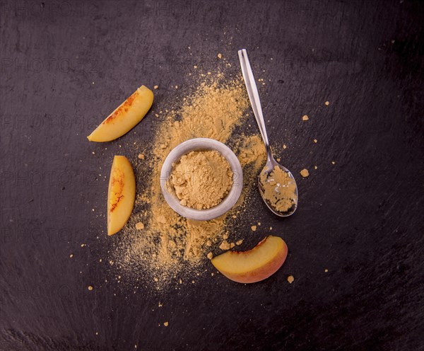 Peach powder on a vintage slate slab as detailed close-up shot, selective focus