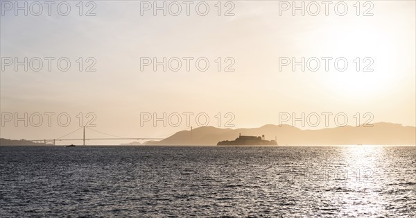 Alcatraz Island at sunset with Golden Gate Bridge in the Background