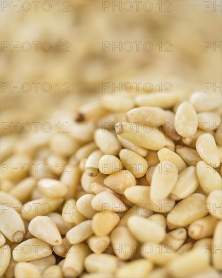 Portion of fresh Pine Nuts (close-up shot, selective focus)