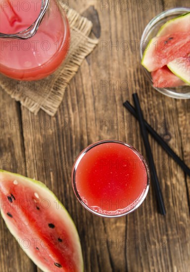 Watermelon Smoothie on rustic wooden background (close-up shot)