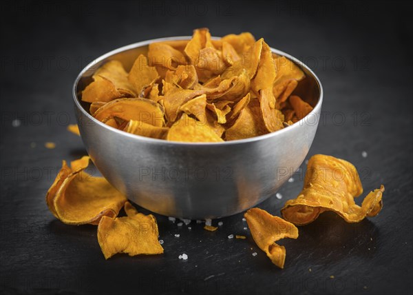 Homemade Sweet Potato Chips on vintage background selective focus, close-up shot