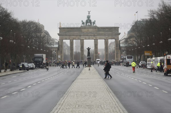 People crossing the road near the Brandenburg Gate on a day of political protest. Berlin, Germany,