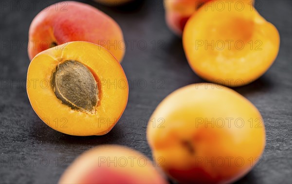 Portion of Fresh Apricots on a rustic slate slab (selective focus, close-up shot)
