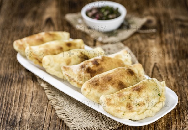 Portion of fresh homemade Empanadas as detailed close-up shot, selective focus