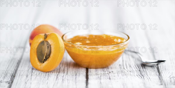 Fresh made Apricot Jam on a vintage background (close-up shot)