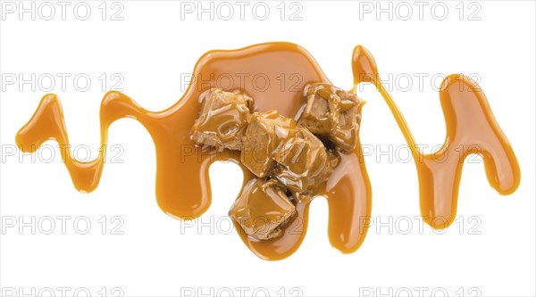 Caramel Sauce on a vintage slate slab (close-up shot, selective focus)
