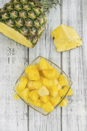 Fresh made Pineapple (sliced) on a vintage background as detailed close-up shot