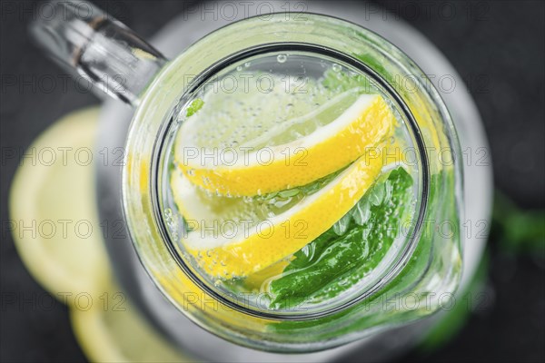 Portion of Lemonade as detailed close up shot on a slate slab (selective focus)
