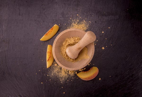 Peach powder on a vintage slate slab as detailed close-up shot, selective focus