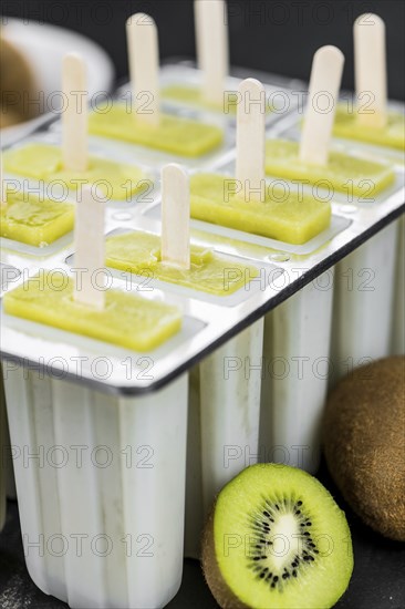Kiwi Popsicles on a vintage looking slate slab (selective focus)