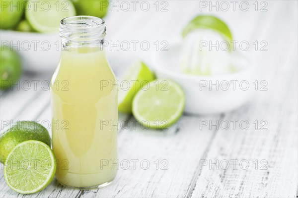 Portion of fresh Lime Juice (close-up shot, selective focus)
