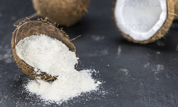 Some fresh made Coconut flour on a vintage slate slab (selective focus)